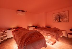 A bed or beds in a room at Hôtel Causse Comtal Rodez, The Originals Relais