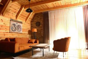 a living room with a couch and a table at Mountain Villas Žabljak in Žabljak