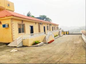 a building with stairs next to a dirt road at تلال الريف in Baljurashi