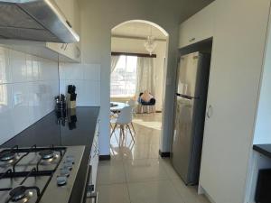 a kitchen with a stove and a refrigerator at Beach Retreat in Henley Beach South