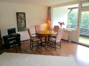 a dining room with a table and chairs and a television at Spacious Roof Top Maisonett Apartment in PRIEN at Lake Chiemsee in Stock