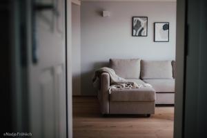 a living room with a couch and a chair at Ferienwohnung Schauplats in Innsbruck