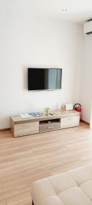 a living room with a flat screen tv on a wall at Apartman Anita in Jesenice