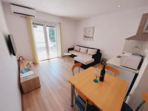 a small living room with a table and a couch at Apartman Anita in Jesenice