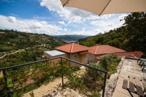 a view of a house with an umbrella at Quinta da Bouça - Agroturismo in Paços de Gaiolo