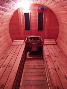 an inside view of a sauna with a wooden floor at Chalupy Vichrovky in Bělá pod Pradědem