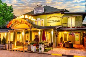 a yellow building with a patio in front of it at Penzion Blesk in Ružomberok