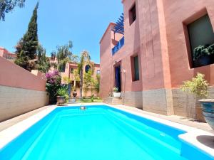 a swimming pool in the backyard of a house at CYCAS VILLA TARGA GARDEN -Only Family in Marrakesh