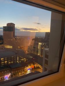 a view of a city at night from a window at Morden 1 bedroom City- Apt Central stylish living in Croydon