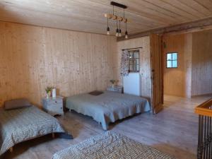 a bedroom with a bed and a refrigerator in it at La Grange de Bois de Chêne in Phalsbourg