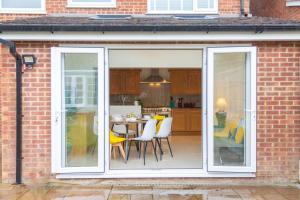 a sliding glass door with a table and chairs at Centrally Located accommodation near town center in Kent