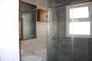 a bathroom with a shower and a toilet at Apartamento frente al mar in Radazul +41 photos