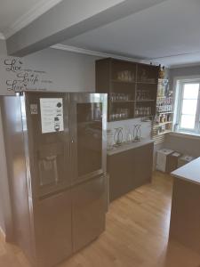 a kitchen with a stainless steel refrigerator and a counter at Sentrumsleilighet med gratis parkering til leie in Arendal