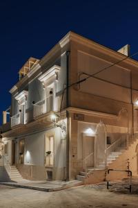 a building with stairs on the side at night at LE MAIOLICHE - Apulian B&B in Grottaglie
