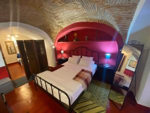 a bedroom with a large bed with a red ceiling at GALLEGOS16 in Cáceres