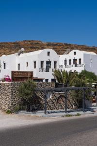 a row of white buildings on a hill at Soulis Hotel in Oia