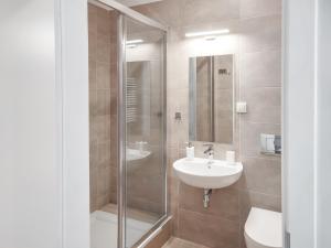 a bathroom with a glass shower and a sink at Apart Hostel S8 in Blizne Jasińskiego +170 photos