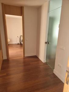 an empty room with a hallway with wood floors and a door at UNIQUE MODERN HOUSE MALAGA - PASEO MARITIMO/CENTER in Málaga