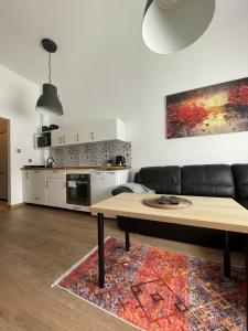 a living room with a couch and a table at Mini apartament Ostróda in Ostróda