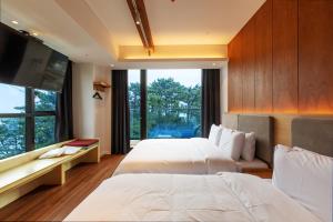 Tempat tidur dalam kamar di The Club Hotel Gijang Yeonhwari