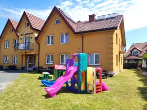 a group of playground equipment in front of a house at Willa Aleksander in Rowy