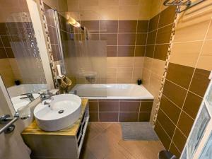 a bathroom with a sink and a bath tub at Apartmán Crocus 313 in Štrbské Pleso