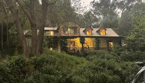 a large house in the middle of a forest at Le Petit Chateau Homestead Bridgetown in Bridgetown