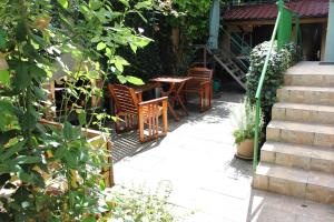 a patio with chairs and a table and stairs at West Capital in Zagreb