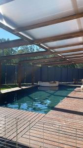 a large swimming pool with a canopy over it at O Celeiros in Freixo