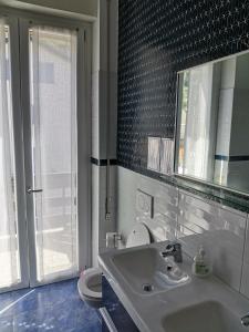 a bathroom with a sink and a toilet and a mirror at La Casa Del Quirino in Tirano +11 photos