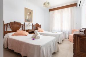 a bedroom with two beds with a stuffed animal on top of it at Villa Roses - Alcúdia in Alcudia +29 photos