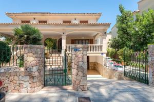 a large house with a gate in front of it at Villa Roses - Alcúdia in Alcudia