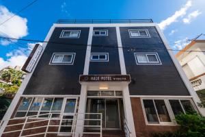a tall black building with a sign that reads hire fraud museum at Hale Hotel Miyakojima in Miyako Island
