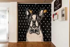 a picture of a dog wearing a bow tie at Hale Hotel Miyakojima in Miyako-jima