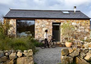 a bike parked outside of a stone cottage at Fernwood in Clifden