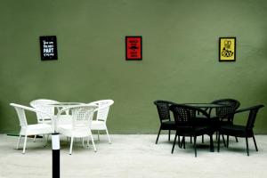a group of black and white chairs and a table at Hotel The Spades in Zirakpur