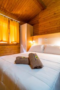 a bedroom with two beds with towels on them at Italia Family Camping Village Viareggio in Torre del Lago Puccini