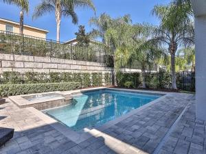a swimming pool in a yard next to a fence at Luxurious 6 bedroom Villa with private pool & Spa in Orlando