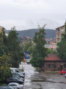a parking lot with cars parked in a parking lot at Луксозен апартамент с WiFi на 10км от Боровец in Samokov