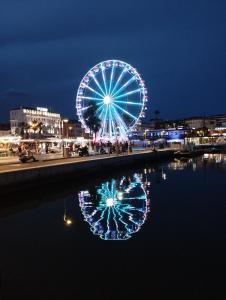 a ferris wheel with its reflection in the water at night at Ferretti 36 ' Bateau à Quai Vieux-Port Cannes Festival La Croisette in Cannes