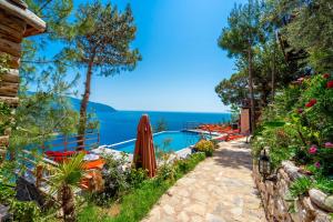 a swimming pool with a view of the ocean at MANZARA BUNGALOW in Fethiye