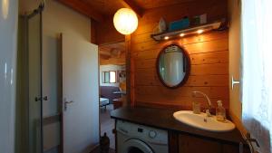 a bathroom with a sink and a mirror at Les Chatcureuils in Montclar +18 photos