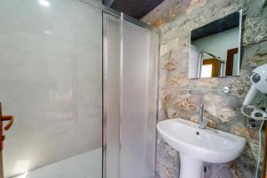a bathroom with a sink and a shower at MANZARA BUNGALOW in Fethiye