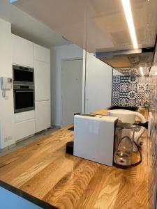 a kitchen with a counter with a blender on a wooden floor at Superbe T2 avec parking et loggia in Marseille