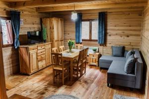 a living room with a table and a couch at Magurska Ostoja in Jasło