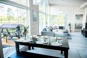 a living room with a table and a couch at Villa Kuulas in Sääskilahti