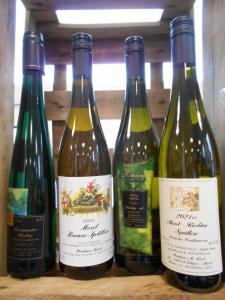 four bottles of wine sitting on a shelf at Wohnung Feuerberg mit Südbalkon in Ediger-Eller
