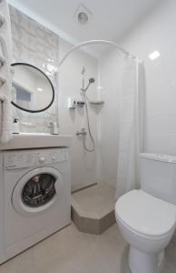 a white bathroom with a toilet and a washing machine at MYFREEDOM Апартаменти метро Сирець in Kyiv