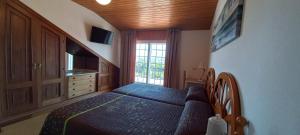 a bedroom with a bed and a large window at Casa Angelina in O Grove