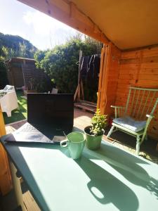 a laptop on a table with a cup and a chair at Blacksheep Sagres Guesthouse & Surf in Sagres +52 photos